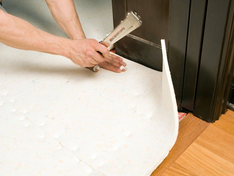 Installing underlayment products from A.T. Frank Floors Across Michigan